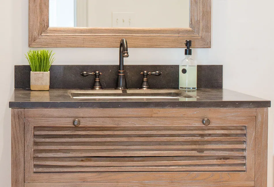 The vanity and mirror used in the powder room  of The Arched Manor