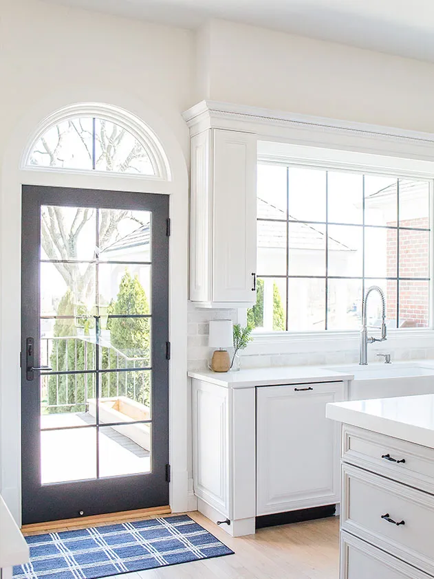 The kitchen received a new door with black grilles and a large black grille window over the sink.