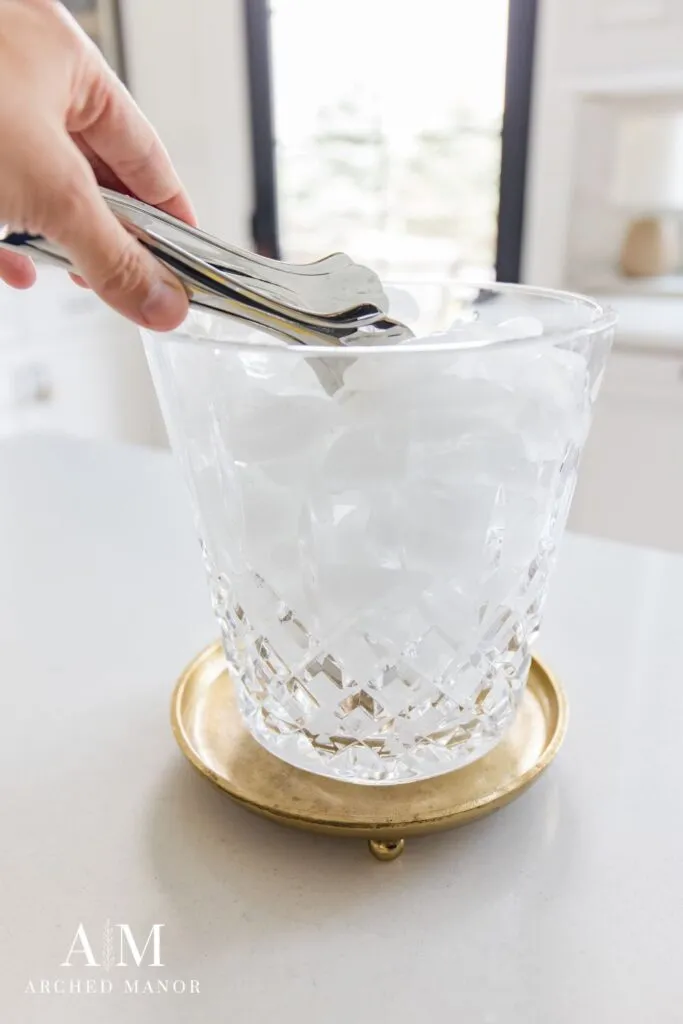 ice tongs in crystal ice bucket