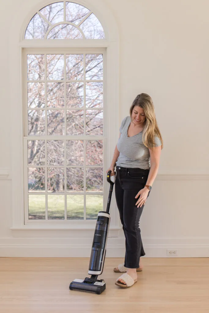 spring cleaning refresh, Megan using cordless wet dry vacuum cleaner to clean wood floords