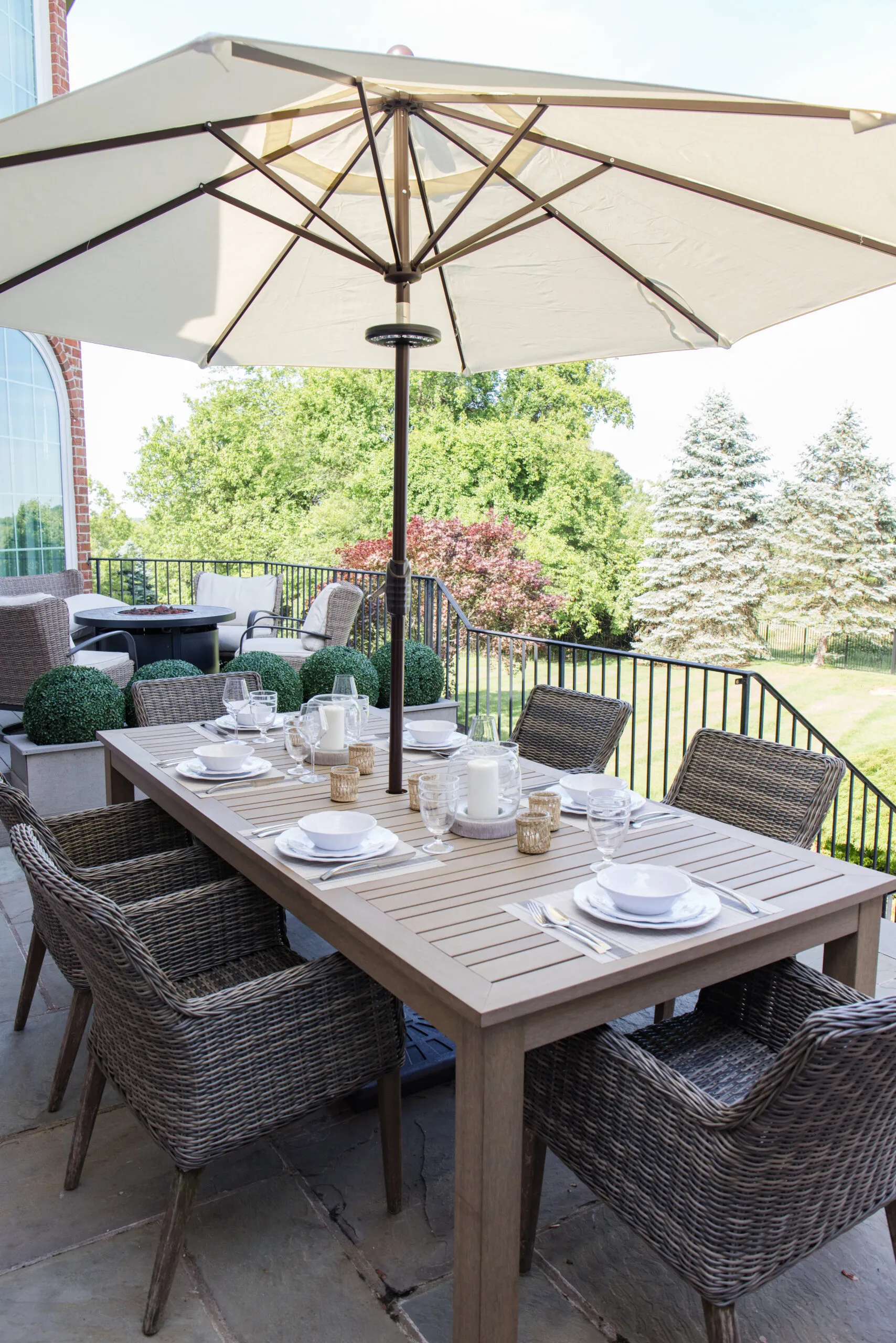 the arched manor, outdoor patio dining styling and decor, dining table with patio umbrella and dinnerware set