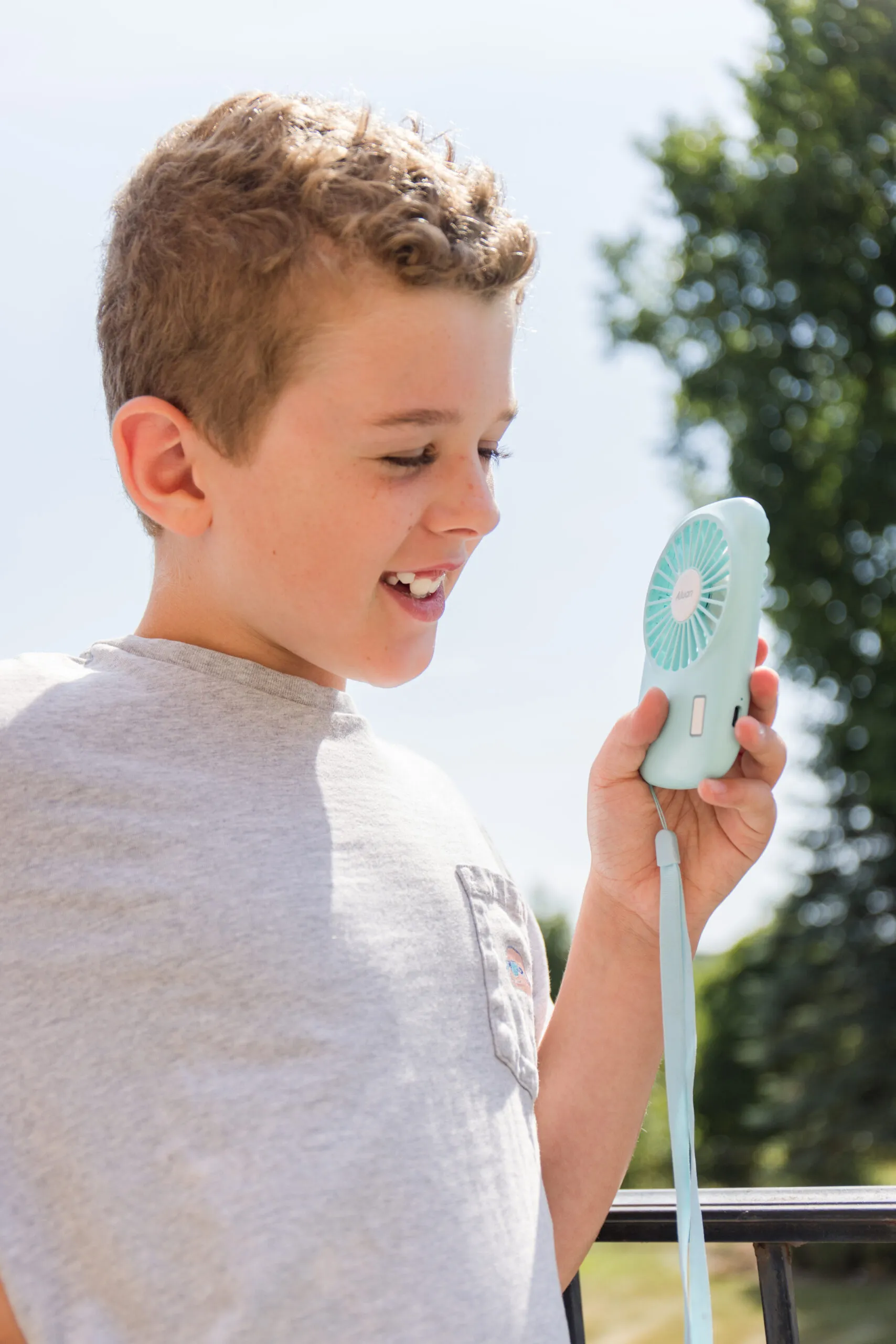 real-life image using a light blue handheld fan
