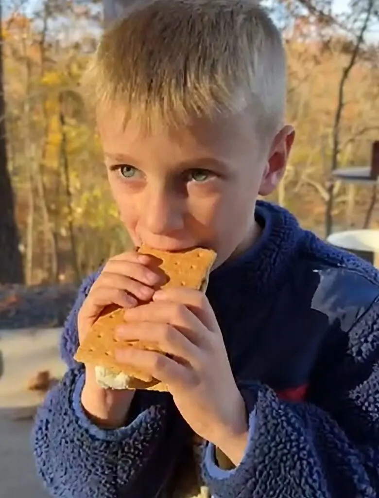 Charlie chowing down on a large s'more