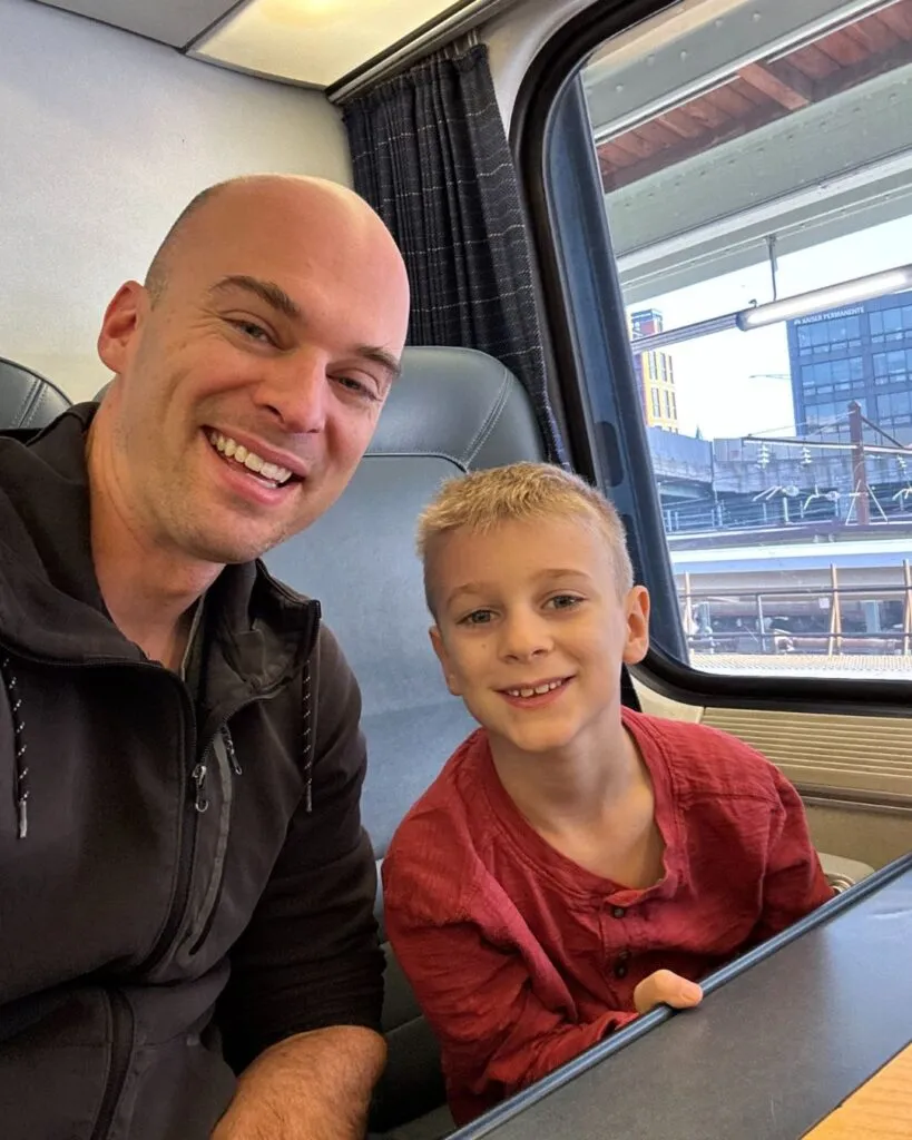 John and Charlie at one side of the four person table on the Amtrak Accela.
