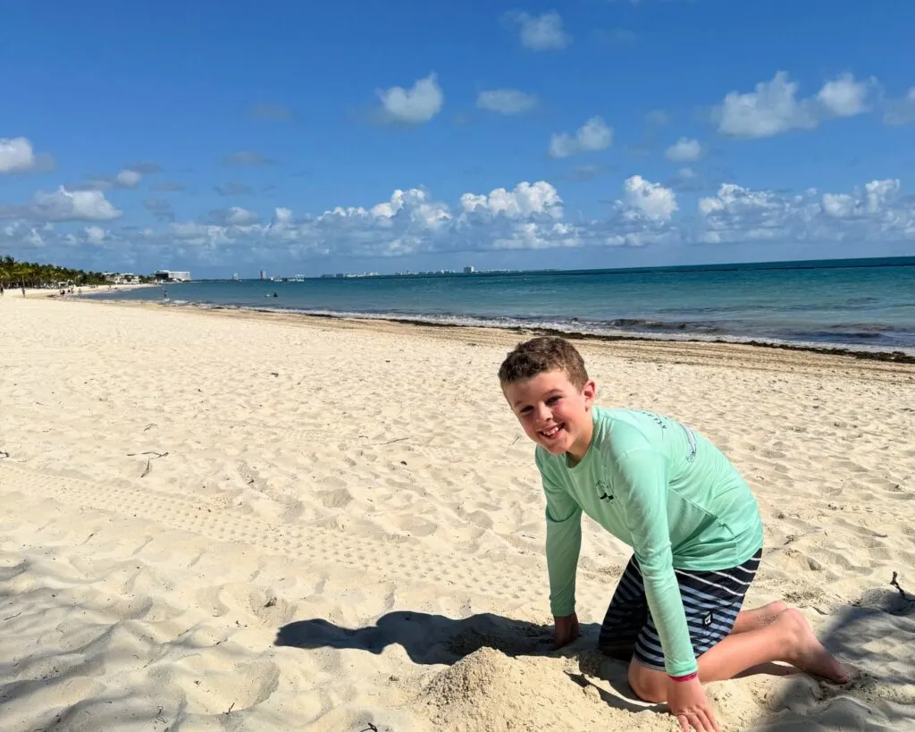 Tristan playing in the sand on the beach by Joe's Deck.