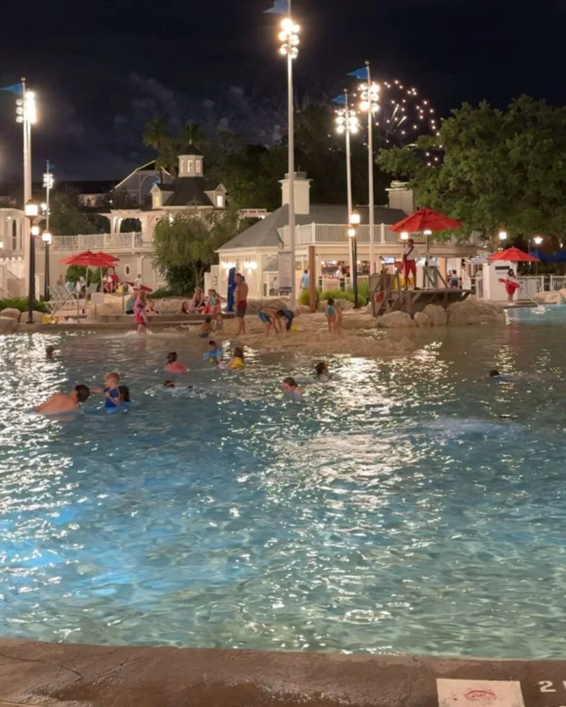Stormalong Bay Pool at night with the Epcot fireworks show